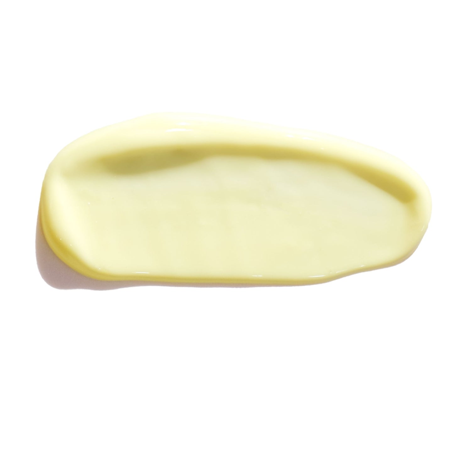 Pale yellow eye cream swatch, smooth texture shown against a white background.