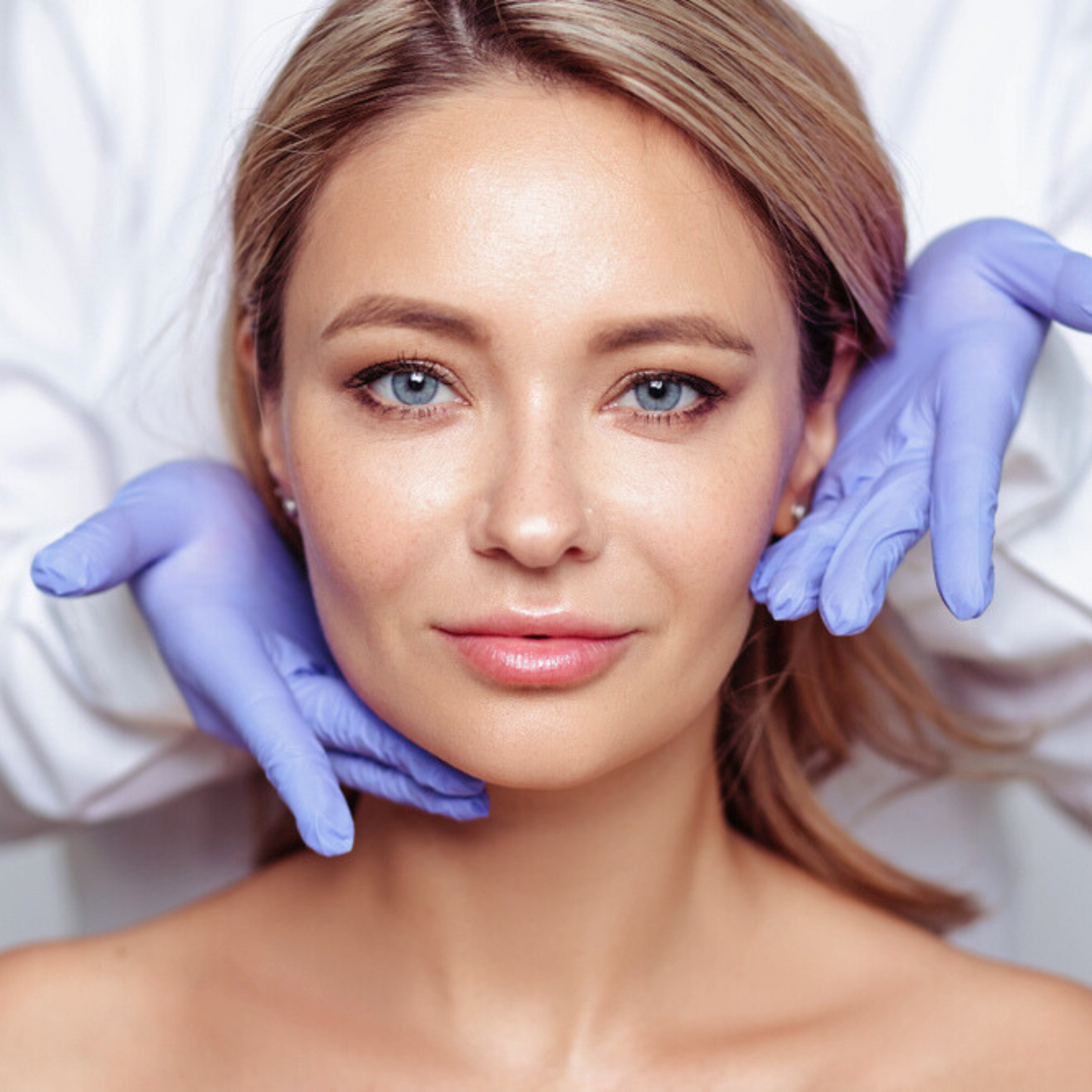 Close-up of a woman receiving a facial treatment, showcasing healthy skin.