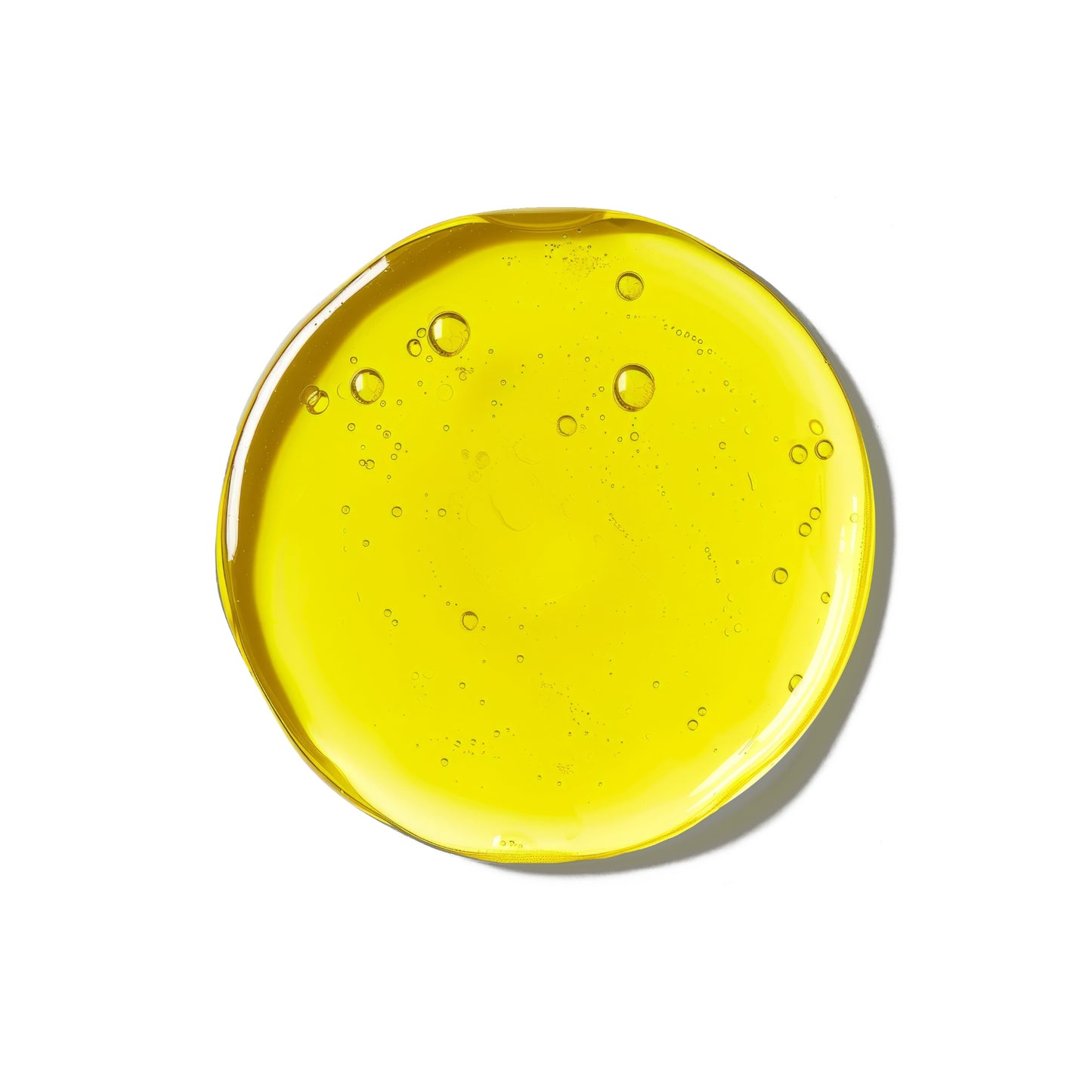 Bright yellow serum sample with air bubbles, showcasing its texture.
