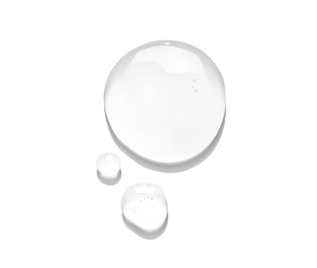 Clear serum drops on white background