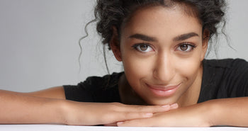 Close-up portrait of a woman with healthy, glowing skin that reflects peptide moisturizer benefits for hydration and skin comfort.