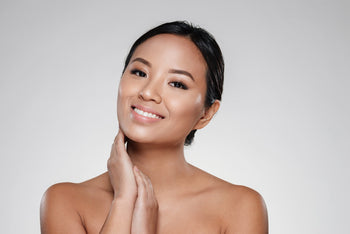 Woman with smooth, radiant-looking skin after cleansing, illustrating vitamin C cleanser benefits for glow and brightness.