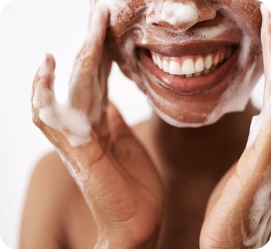 Woman cleansing face as the first step before applying vitamin C serum