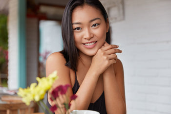 Smiling woman with smooth, even-looking skin, representing results associated with choosing the best at-home chemical peel for melanin-rich skin tones.